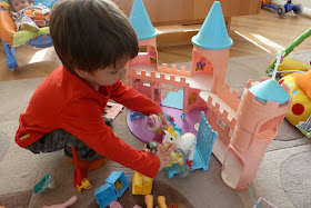 Boy playing with vintage My Little Ponies