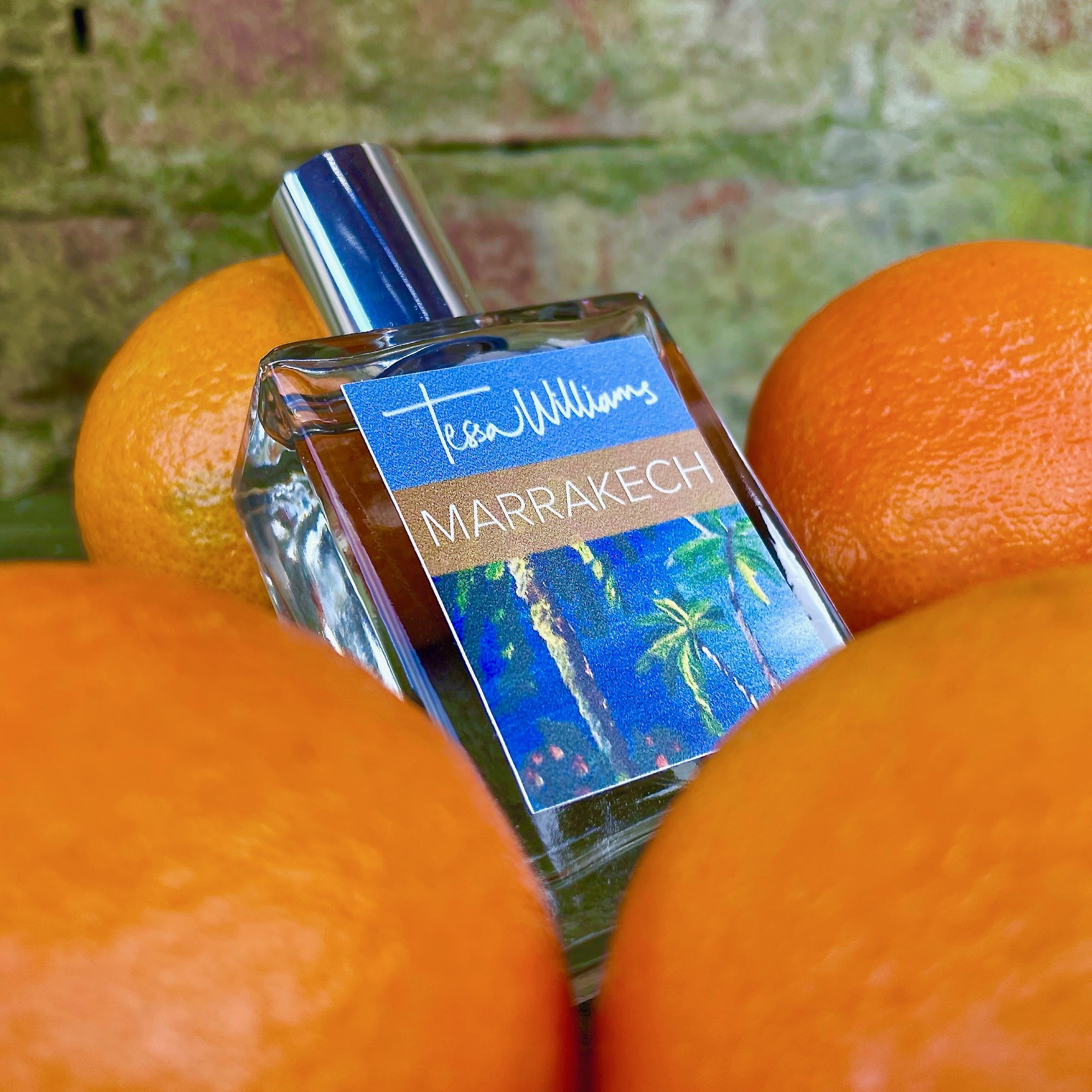 Marrakech perfume by Tessa Williams - the bottle surrounded by oranges