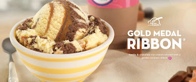 A scoop of Baskin-Robbins Gold Medal Ribbon ice cream in a bowl.