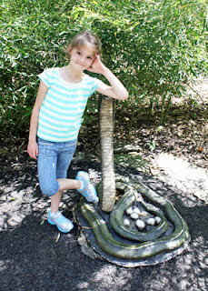 After a few frightening seconds, Tessa realized this snake statue wasn't the real deal and wanted her picture taken with it.