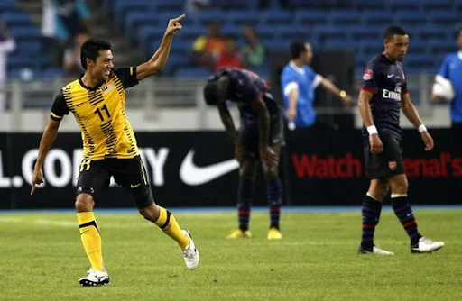 Malaysia XI player Mohamad Azmi Muslim celebrates after scoring against Arsenal