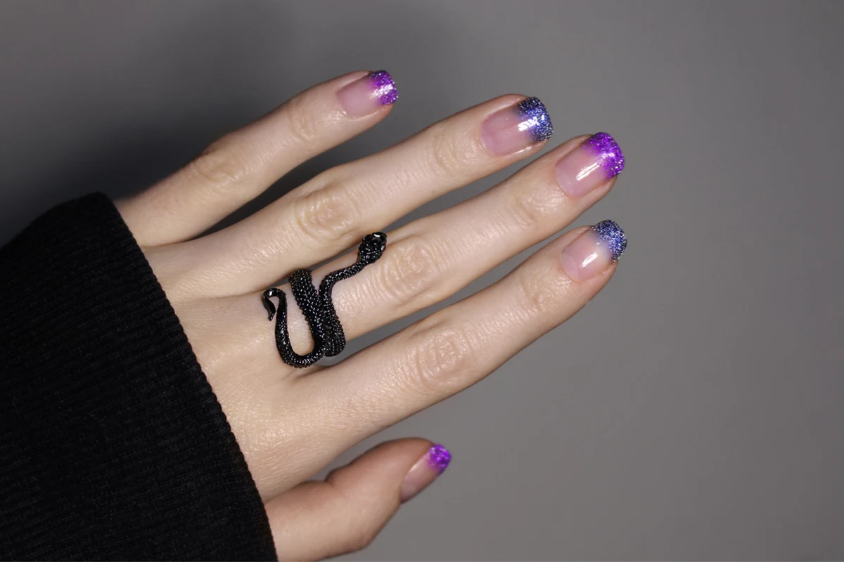 close-up of a hand with alternative, glitter nail look for summer