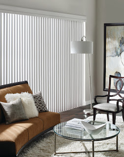 The curved vanes of Cadence Soft Verticals mimic soft drapery folds over a sliding glass door.