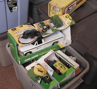 A tote full of John Deere die cast collectible toys.