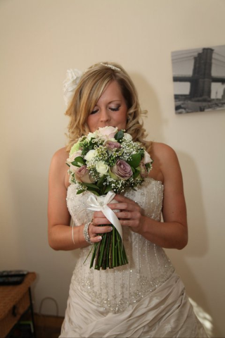 The Bridal Bouquet was tied in satin ribbon and lace with a vintage button