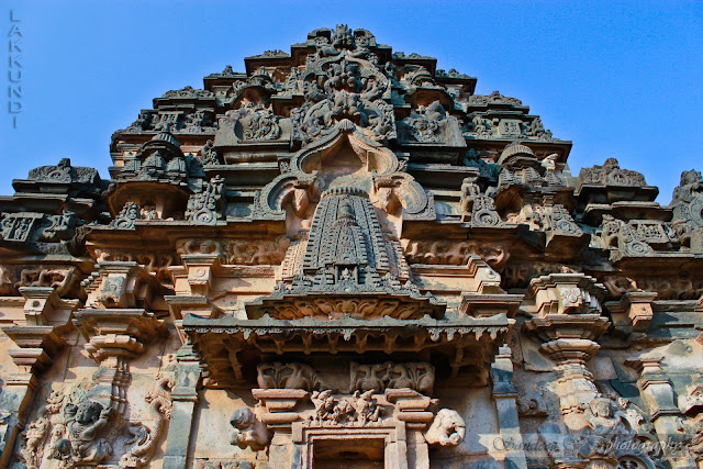 Kirthimukha (legendary face) with miniature tower–decorative arch combination going up the shrine superstructure