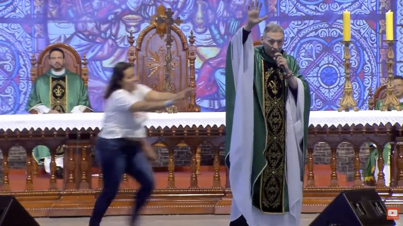  Woman Pushed Priest Off Stage During Mass (Video And Photos)