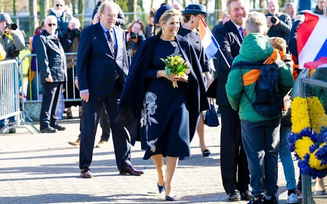 Queen Maxima wore a new stretch wool long sleeve embossed dress by Oscar de la Renta, and navy wool coat by Natan