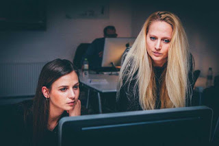 Two women looking at a computer screen