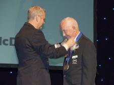 Retired NASA Apollo program astronaut James McDivitt (right) is presented with a medal by Ron Smith, vice-mayor of the City of Lancaster, Calif., at the city’s Aerospace Walk of Honor induction ceremonies Sept. 19