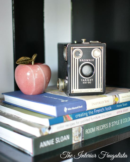 Stack books and place small objects on top when styling a bookcase