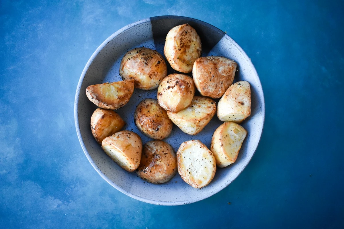 crispy roast potatoes in a grey bowl