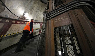 Work up the stairs abandoned subway station Down Street in London. 