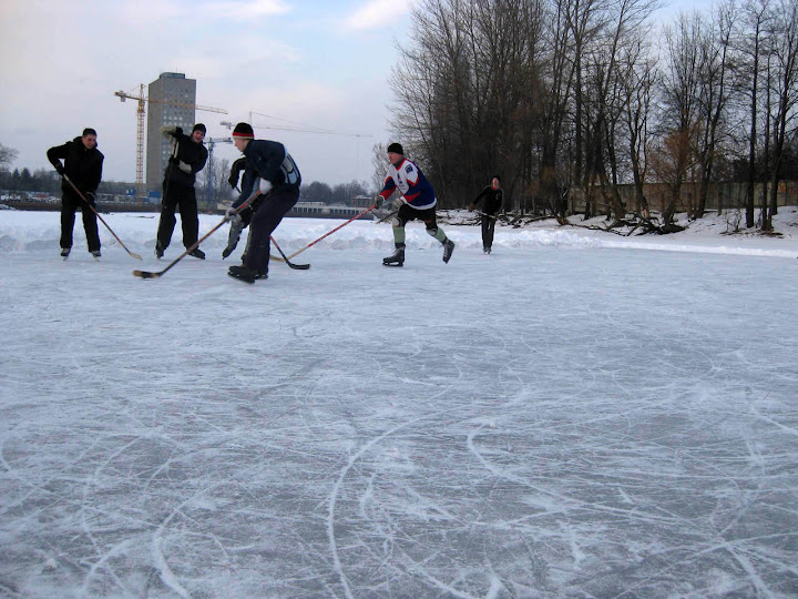 People playing Ice hockey on river