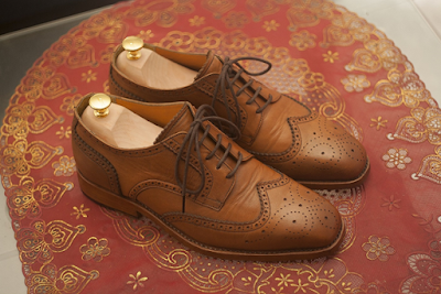 A Brown Pair of Wingtip Derby Shoes on Table
