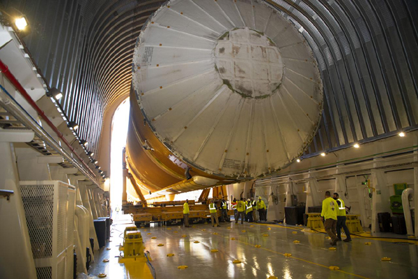 Technicians place the SLS core stage booster inside the Pegagus barge at NASA's Stennis Space Center in Bay St. Louis, Mississippi...on April 20, 2021.