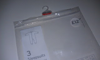 A plastic zip-lock back with hanger; packaging for some baby sleepsuits.