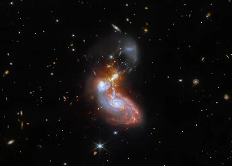 Two galaxies merge into one.