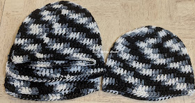 Sweet Nothings Crochet free crochet pattern blog, free crochet pattern for a chemo cap, photo of chemo caps 1 made with black n white multi colored yarn,
