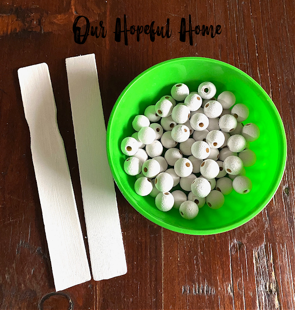 white painted beads green bowl paint stirrers