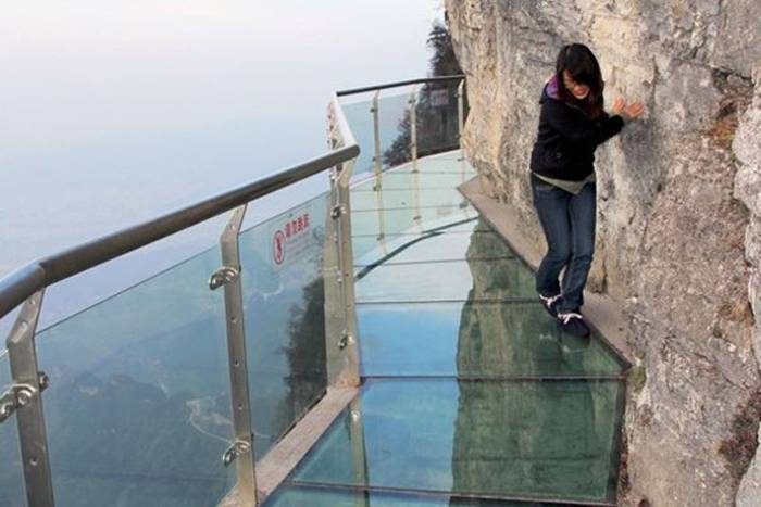 Jutting out from a sheer cliff 1,430 meters high, the glass skywalk in Zhangjiajie National Forest Park offers sightseers terrifying thrills and clear view of the mountains below as they tread nervously across the 60 meter long bridge encircling the vertical cliffs of Tianmen Mountain in Hunan province. The 3ft-wide, 2.5in thick glass walkway is so scary that sightseers are requested to wear cloth slip-ons over their shoes when they cross the skywalk, presumably to make the job easier for the cleaners.
