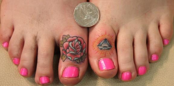  tattoo on her thumb and Bailey's traditional rose tattoo on her toe