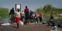 Displaced people collecting water on the banks of the River Nile, Awerial County, South Sudan. (Image Credit: Geoff Pugh/Oxfam East Africa via Flickr) Click to Enlarge.