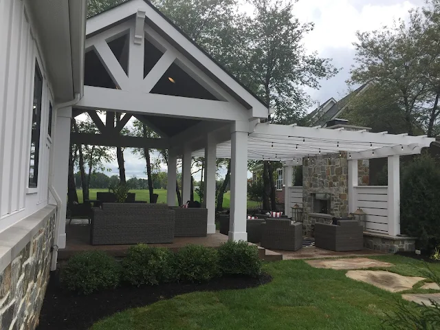 white pergola with lights and fireplace