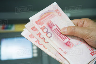 hand holding chinese yuan