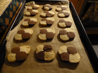 15 or so white and brown checked square biscuits.