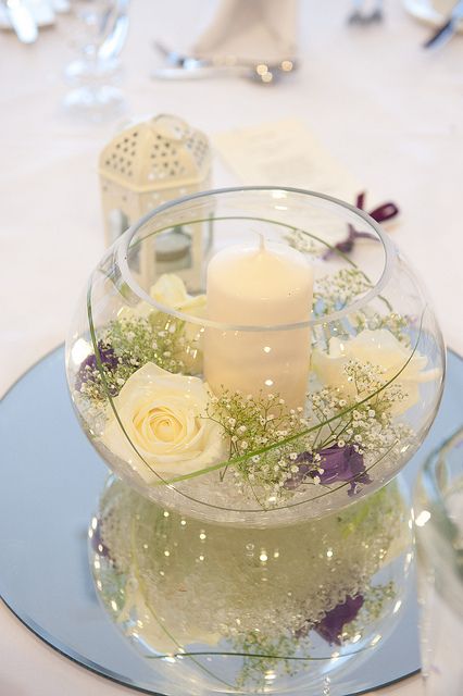 fish bowl masterpiece decoration idea with flowers and candles and many roses
