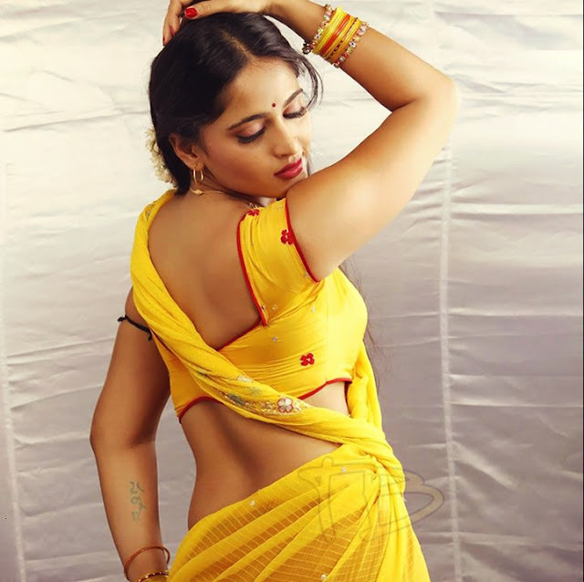 anushka shetty navel showing yellow saree stills