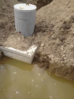 Septic tank sits just below the footings and is higher than the location of the field 