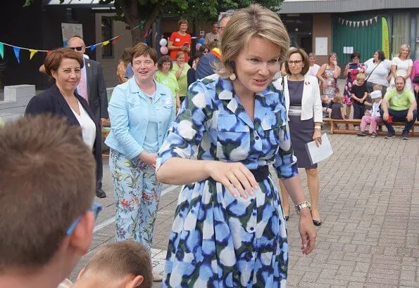 Queen Mathilde visits Playground Space summer camp in Zoutleeuw. The Queen wore Natan blue print midi shift dress
