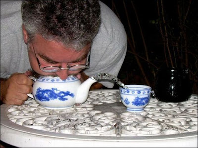 An unusual way to pour water to a cup of tea