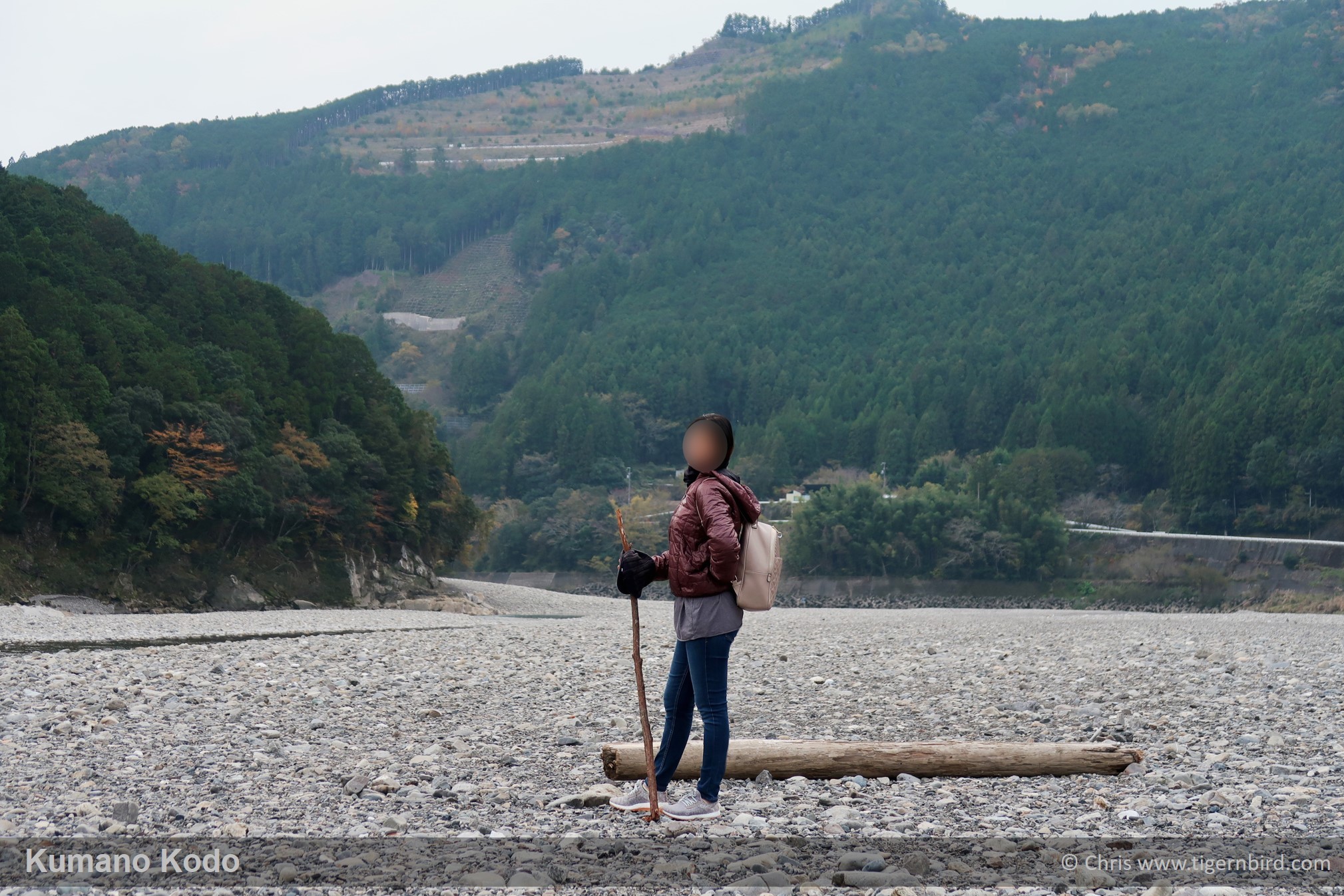Hiker standing in stony Kumano riverbed near the Kumano Kodo trail in Japan