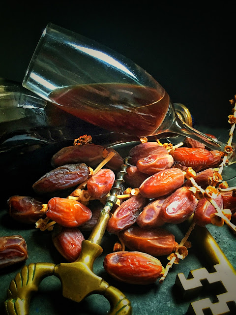 "Homemade Dates Wine: An enticing art of crafting exquisite beverage using fresh dates, sugar, and a touch of cinnamon."