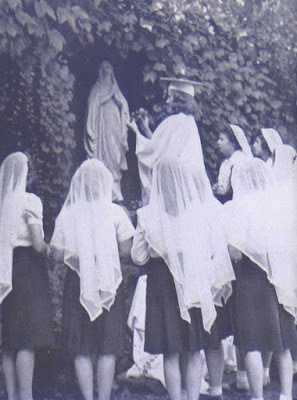 Student crowning Mary statue