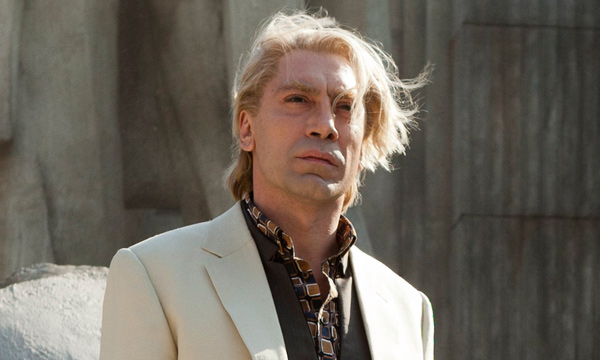 Javier Bardem as Raoul Silva in tan suit with long blond hair fluttering in the wind