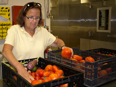 Nancy Haney check out tomatoes from the Tri-County garden (photo provided by Tri-County)