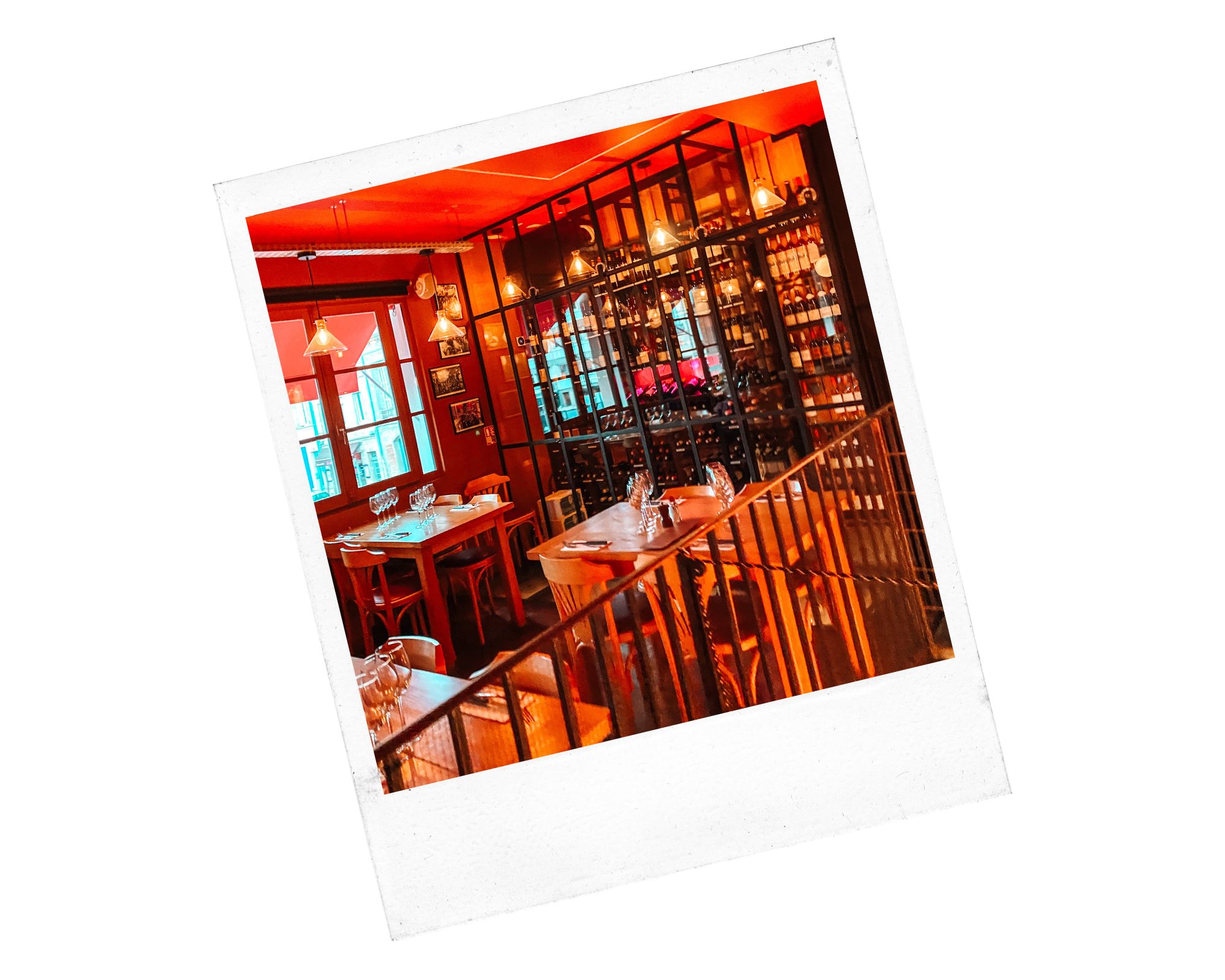 l'intérieur du restaurant le carré aux chartrons à bordeaux avec des tables et des chaises en bois et des bouteilles de vin dans une vitrine au fond