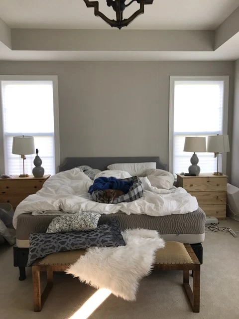 Bedroom with bed between two windows