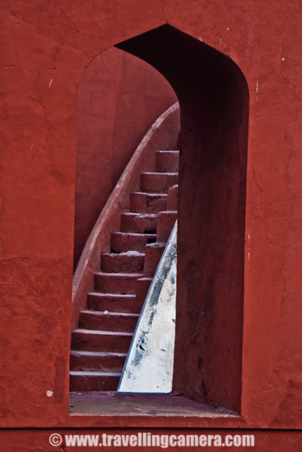 Some Experiments with old architecture of Jantar Mantar in Delhi, INDIA : Posted by VJ SHARMA on www.travellingcamera.com : Last month me and one of my friend were waiting for other folks to reach Connaught Place in Delhi and they called us to inform that all of them are arriving after 1:30 Hrs... This was good opportunity for us to explore some place nearby and decided to visit Jantar Mantar... After reaching the place I was not able to decide what should I shoot... Everywhere people were roaming and it was really difficult to find a place without people... and it was not like two or three folks.. It was huge crowd in front of each yantra @ Jantar Mantar.. So finally I decided to have some photographs which can avoid this crowd and it gave a good opportunity to place with various angles/compositions... check out and critics are welcome !!The first photograph where I wanted to have darkest possible shadows to make it look like black tiles in contact with reds and white ones.. Although it doesn't look like that... I would have to wait to click this photograph at right time but we had to move out in few hrs... Never mind, I will try it again...This time I was carrying SONY Alpha-700 and was confused with some of the controls.. Anyway that's not important... These yantras were very narrow is shape and it was difficult to fit myself for clicking these architecture forms nicely... Here is a tilted view of a semi-spherical yantra @ Jantar Mantar...All these photographs from the same yantra and it was was quite interesting... But please don't ask me about how it functions and what it is supposed to do...Stairs hidden behind these structures and everyone needs to follow them to go down and see the real work inside these yantras.. In Jantar Mantar at jaipur, everyone was not allowed to go inside these structures but in Delhi I didn't see such restrictions except one which had highest structure followed by lot of stairs....Jantar Mantar in Delhi is a very popular place among activists, social associations and artists as well... Many of the NGOs choose this place to start a rally or protest... Also many artists have explored this very well and many times Photographers have exhibited this place...A Series of small pillars taking all the weight of small paths connecting outer circle of a structure with a pole in the middle... as you can see the turning path in a circle...One of my friend called it 'Stairs of Success'.. I don't if that is the name of these stairs but like the caption :)Final Photograph showing the close-up view of this architecture which shows the age of this structure and its been repaired multiple times in past which resulted in this roughness... I am again planning to visit Jantar Mantar in Delhi and will ensure that I get full day to spend there...