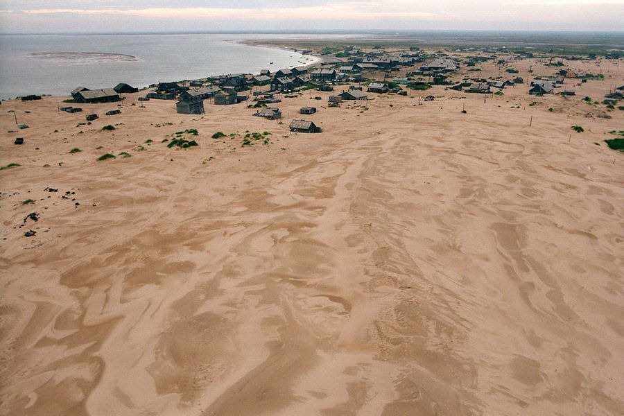 More than one-half of village already buryed nether sandy dunes coming from the West Aug. 2005