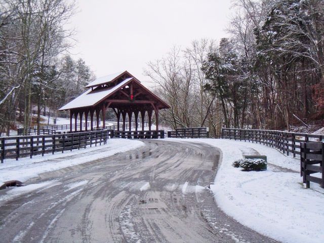 covered bridge entrance with snowfall