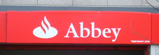 Temporary sign above abbey branch disguising the new Santander sign underneath