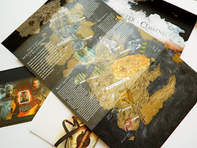 A photo showing a Westeros map from Game of Thrones and some stamps