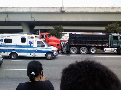 Smart Car sandwiched between 2 trucks