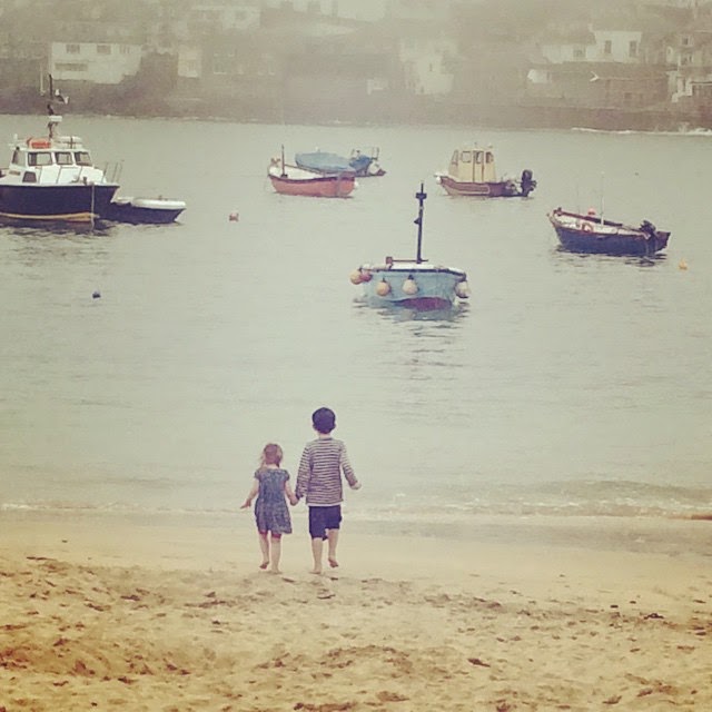 siblings holding hands on St Ives Beach