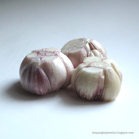 Step 2: slice off the top and bottom of the bulb to expose the ends of the individual garlic cloves